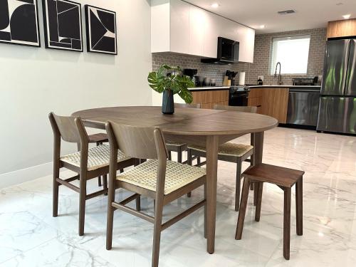 a wooden table and chairs in a kitchen at Townhouse in Heart of South Beach Miami Steps to Sea in Miami Beach
