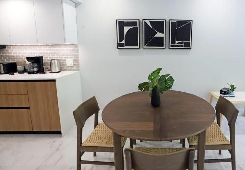 a dining room table with a potted plant on it at Townhouse in Heart of South Beach Miami Steps to Sea in Miami Beach