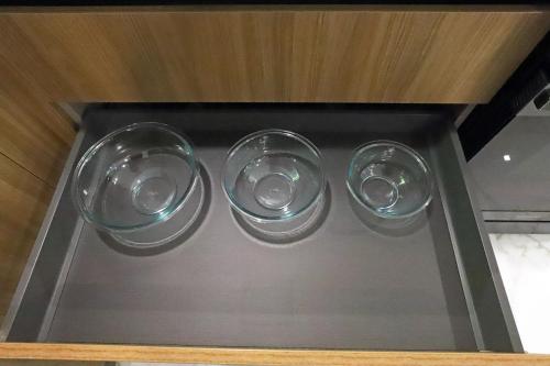 three empty wine glasses sitting on a shelf at Townhouse in Heart of South Beach Miami Steps to Sea in Miami Beach