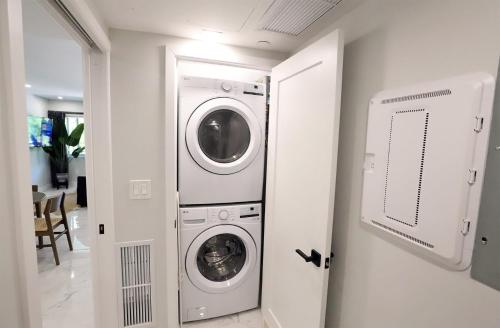 a washer and dryer in a white room at Townhouse in Heart of South Beach Miami Steps to Sea in Miami Beach