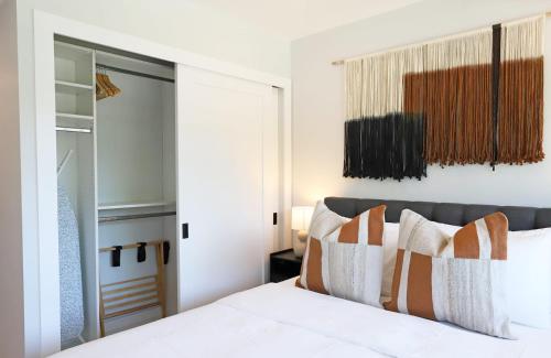 a bedroom with a bed with orange and white pillows at Townhouse in Heart of South Beach Miami Steps to Sea in Miami Beach