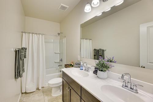 a bathroom with a sink and a toilet and a mirror at Florence Home about 10 Mi to Historic District! in Florence