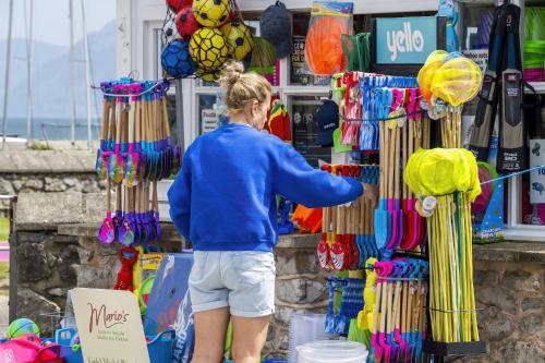 a woman standing in front of a store selling colorfulaments at Ty Hydref in Beaumaris