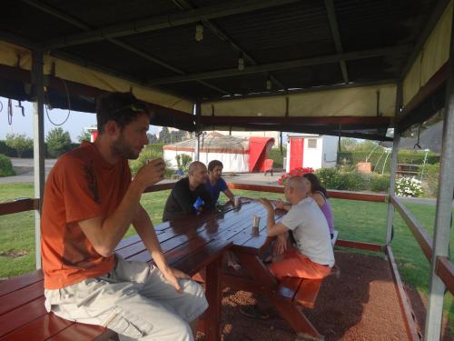 a group of people sitting at a picnic table at Sea of Galilee - Genghis Khan in The Golan in Giv'at Yo'av