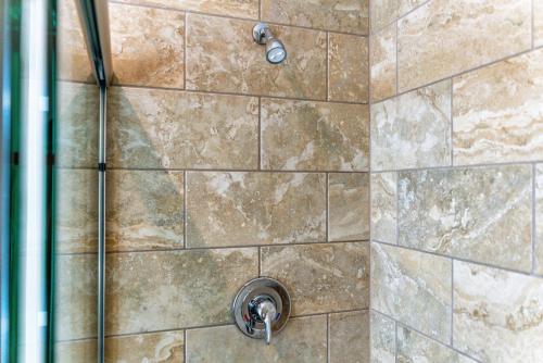 a shower stall with a stone wall at Waterside Suites and Marina in Key Largo