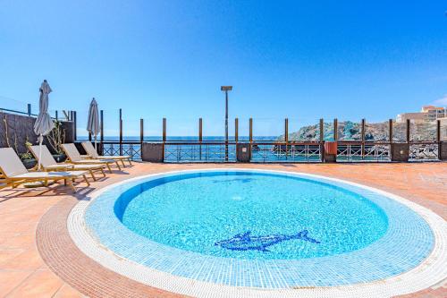 a swimming pool on the roof of a building at Sea view apartment Nautico Suites in San Miguel de Abona
