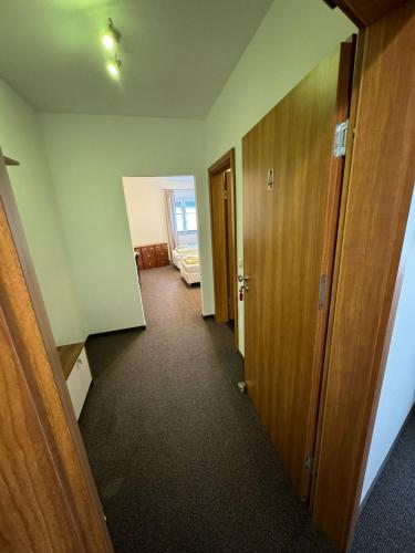 an empty room with a hallway with two doors at Pension Zur Traube 2 in Bergheim
