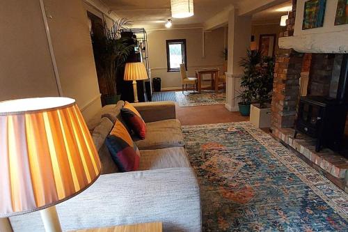 a living room with a couch and a fireplace at Meadow View in Bedford