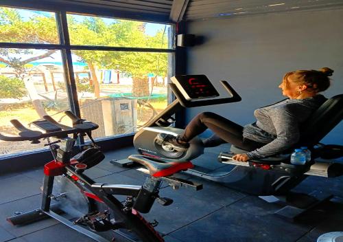 a woman riding on a exercise bike in a gym at Davinci Beach Resort in Hurghada