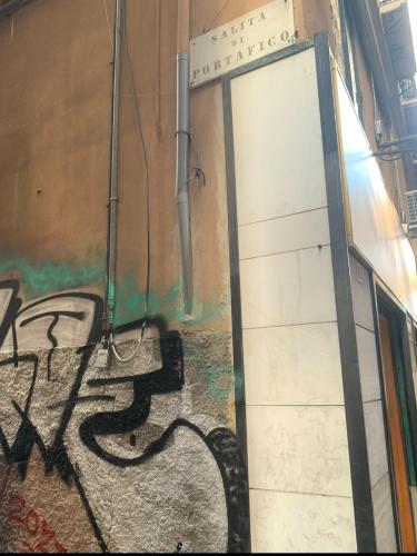 a door in a room with graffiti on the wall at The First Luccoli Garibaldi Rolli in Genova