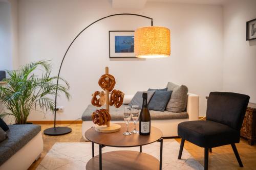 a living room with a couch and a table at Chambre Pin Up Wings in Eguisheim