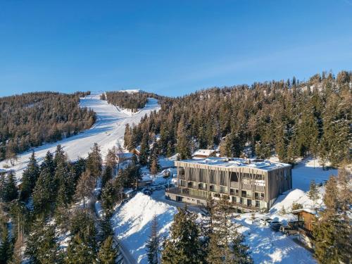 an aerial view of a resort in the snow at Hotel Olangerhof in Valdaora