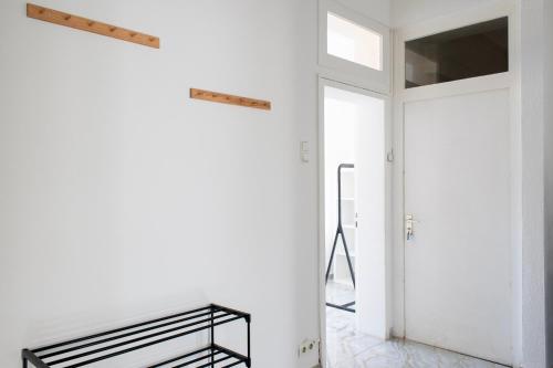 a hallway with a mirror and a white wall at Stay & Work Apartment Rheine in Rheine