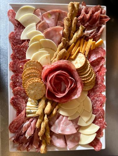 a tray of different types of meats and cheese at Clone House Event Villa in Aughrim