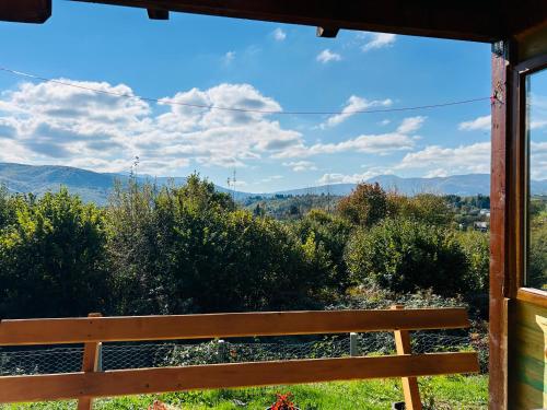 a view from a bench looking out at the mountains at Log cabin in Sejdanovići