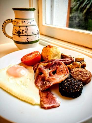 a plate of breakfast food on a table at Clone House Event Villa in Aughrim