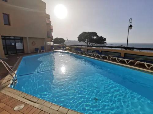 une grande piscine bleue à côté d'un immeuble dans l'établissement Horizon, à Collioure