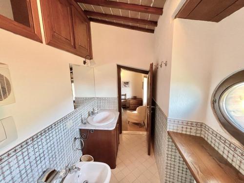 a bathroom with two sinks and a toilet at Exclusive Spoleto Country Park Pool Park Activities Mountain View Sleeps 28 in Acquaiura