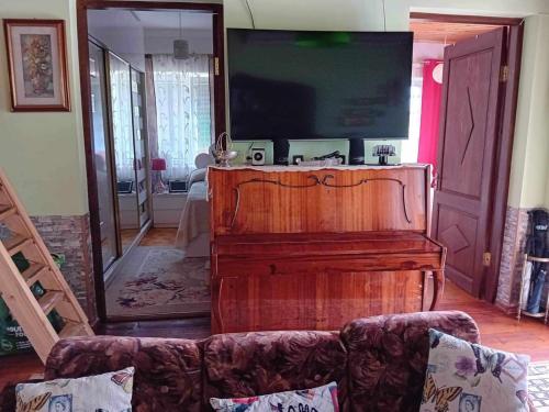 a living room with a couch and a flat screen tv at Ruska's Guesthouse in Kveda-Bashi