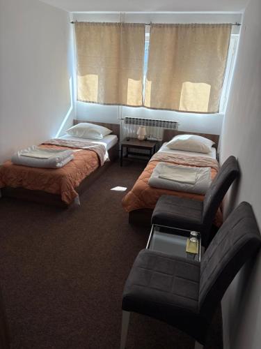 a room with two beds and a window at Hotel Avanti in Zenica