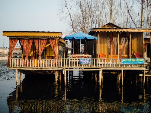 a house on a dock in the water at Veena Palace Group Of Houseboats in Srinagar