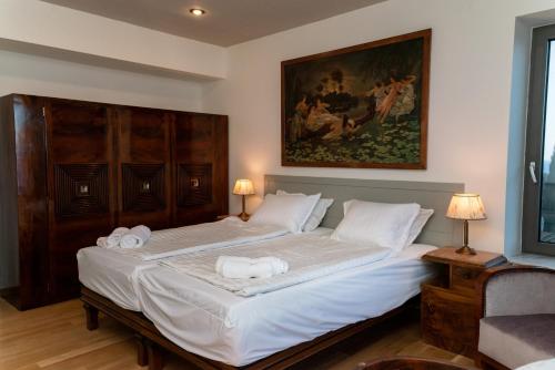 a bedroom with a large bed with towels on it at LEONIDIONHOUSES - The Lykoskufi Villas in Tiros