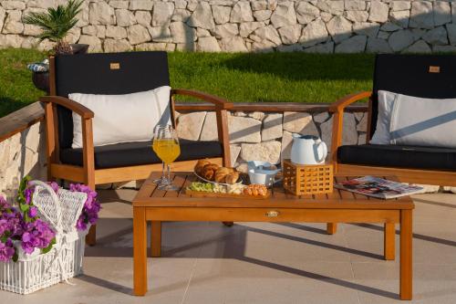 two chairs and a table with a glass of wine at Luxury Villa Luminosa in Split
