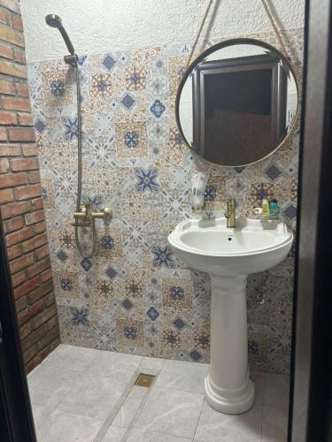 a bathroom with a sink and a mirror at Hotel Riverside Inn in Martuni