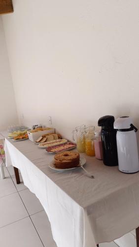 a white table with food and drinks on it at Pousada Coqueiro in Paraty