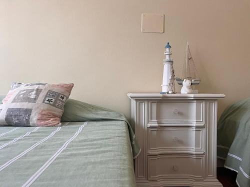 a bed with a night stand with a lighthouse on it at Da' mi' nonni in Pistoia