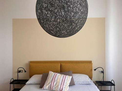 a bedroom with a bed with a large orb on the wall at Da' mi' nonni in Pistoia