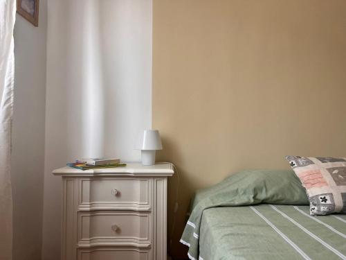 a bed with a nightstand with a lamp on top of it at Da' mi' nonni in Pistoia