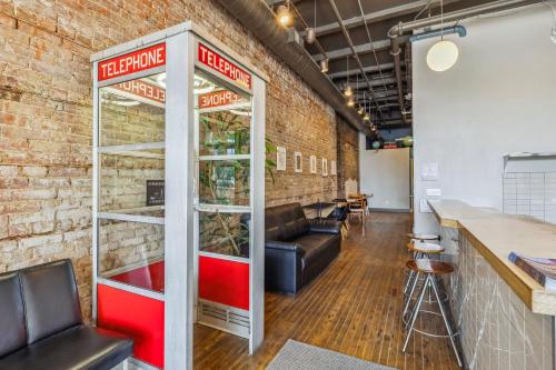 a brick wall with a pizza cart in a room at The Victor 3 - Cleveland's Urban Lodge in Cleveland