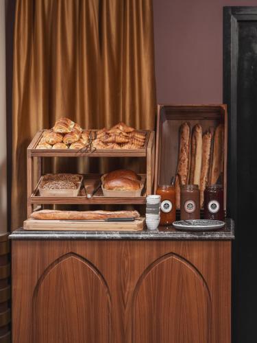 a buffet with bread and pastries on a table at Boudoir des Muses in Paris
