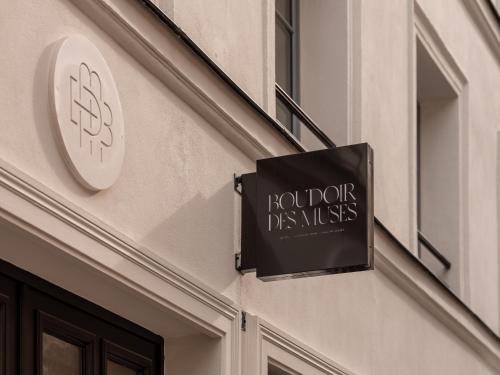 a sign on the side of a building at Boudoir des Muses in Paris