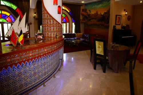 a lobby with a bar with stained glass windows at Riad Noumidya in Fès