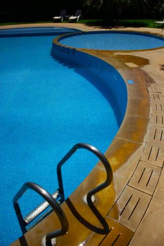 a swimming pool with a metal object in the water at Riad Noumidya in Fès