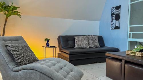 a living room with a chair and a couch at VILLAS EL ENCANTO in Jalpan
