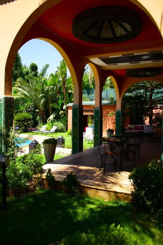 a patio with a table and chairs on it at Riad Noumidya in Fès