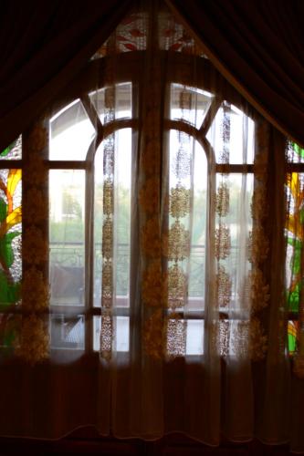 a window with curtains and a view of a room at Riad Noumidya in Fès