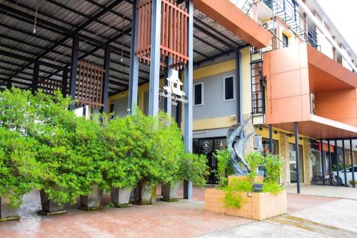 a group of buildings with trees in the courtyard at Chivapuri Trat in Trat