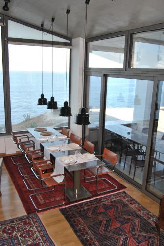 a dining room with a long table and chairs at LEONIDIONHOUSES - The Lykoskufi Villas in Tiros