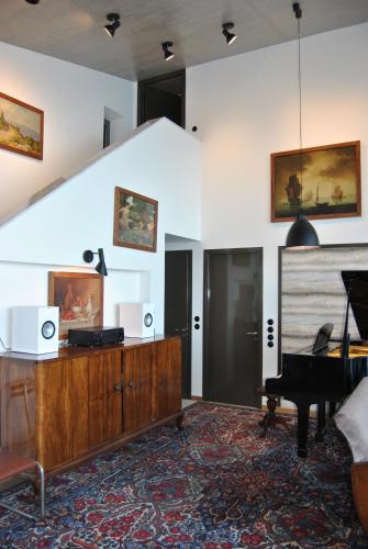 a living room with a piano and a wooden dresser at LEONIDIONHOUSES - The Lykoskufi Villas in Tiros