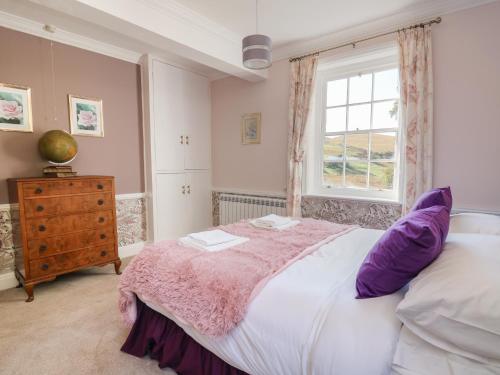 a bedroom with a large bed and a window at Llwynderw Hall in Llanwrtyd Wells