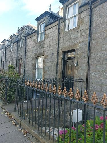 a wrought iron fence in front of a building at Hallmark Guest House in Aberdeen