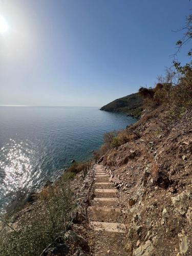 a stairway to the ocean on a cliff at LEONIDIONHOUSES - The Lykoskufi Villas in Tiros