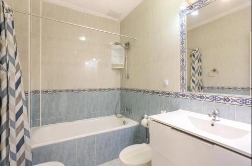 a bathroom with a sink and a toilet and a bath tub at Orihuela Costa Sleeps 6 with Roof Terrace & Pool in Villacosta