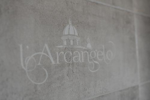 a sign on the side of a building with a tower at B&B L'Arcangelo in Cariati