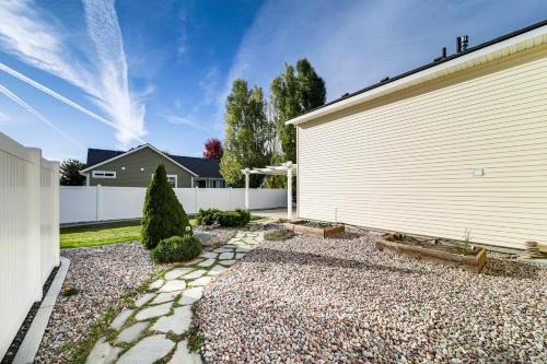 a house with a white garage and a driveway at Spokane Valley Home with Fire Pit - 1 Mi to Trails! in Spokane Valley