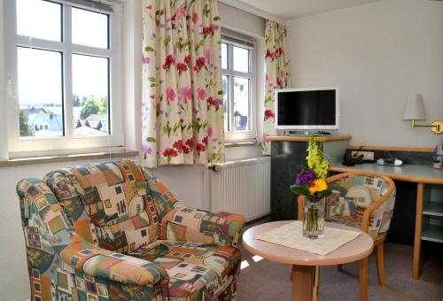 a living room with a couch and a table at Parkhotel Helene in Bad Elster